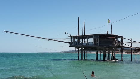 woman swims in sea waters near trabocco at fossacesia, italy