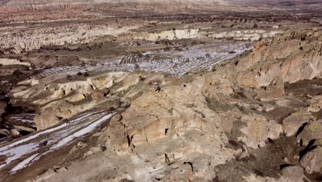 Abenteuer-In-Kappadokien:-Einsamer-Tourist-Sitzt-Auf-Einem-Berggipfel-In-Einer-Höhle-Und-Genießt-Den-Blick-Auf-Die-Weite-Wüstenlandschaft-Von-Göreme-Am-Horizont