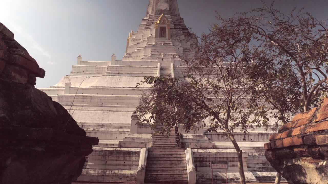 A tilt establishing shot of the spectacular Wat Phy Khao Thong, one of the many beautiful temples in the ancient historical city of Ayutthaya in Thailand