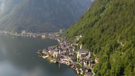 high aerial pullback away from hallstatt, austria in austrian alps