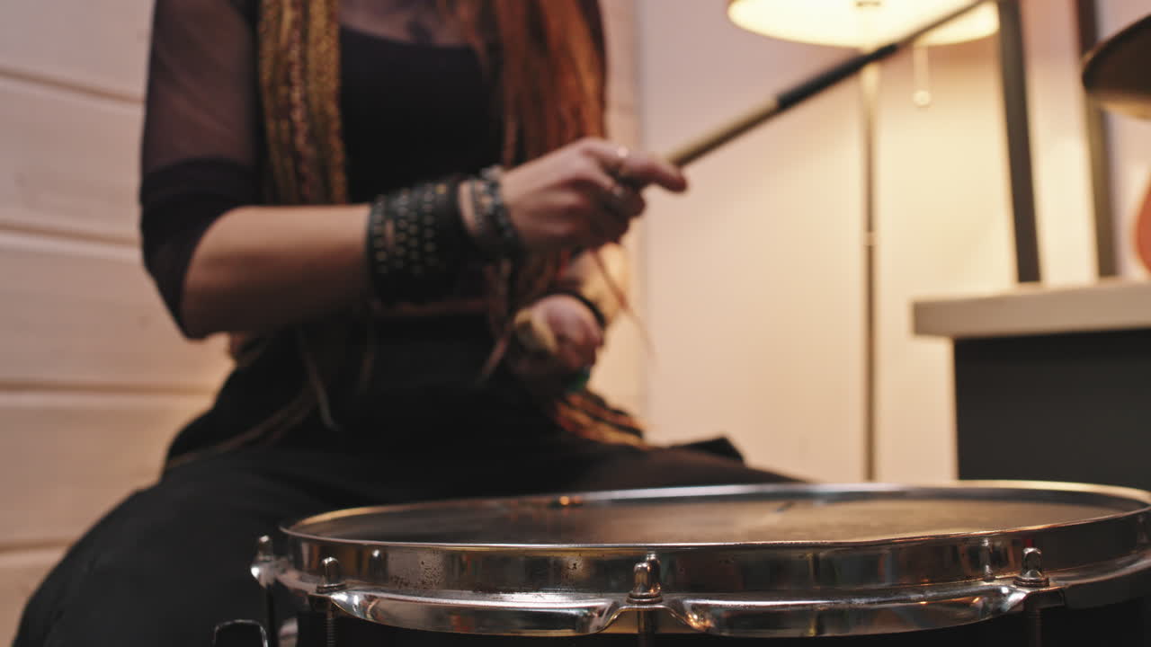 Female Drummer Playing In Studio