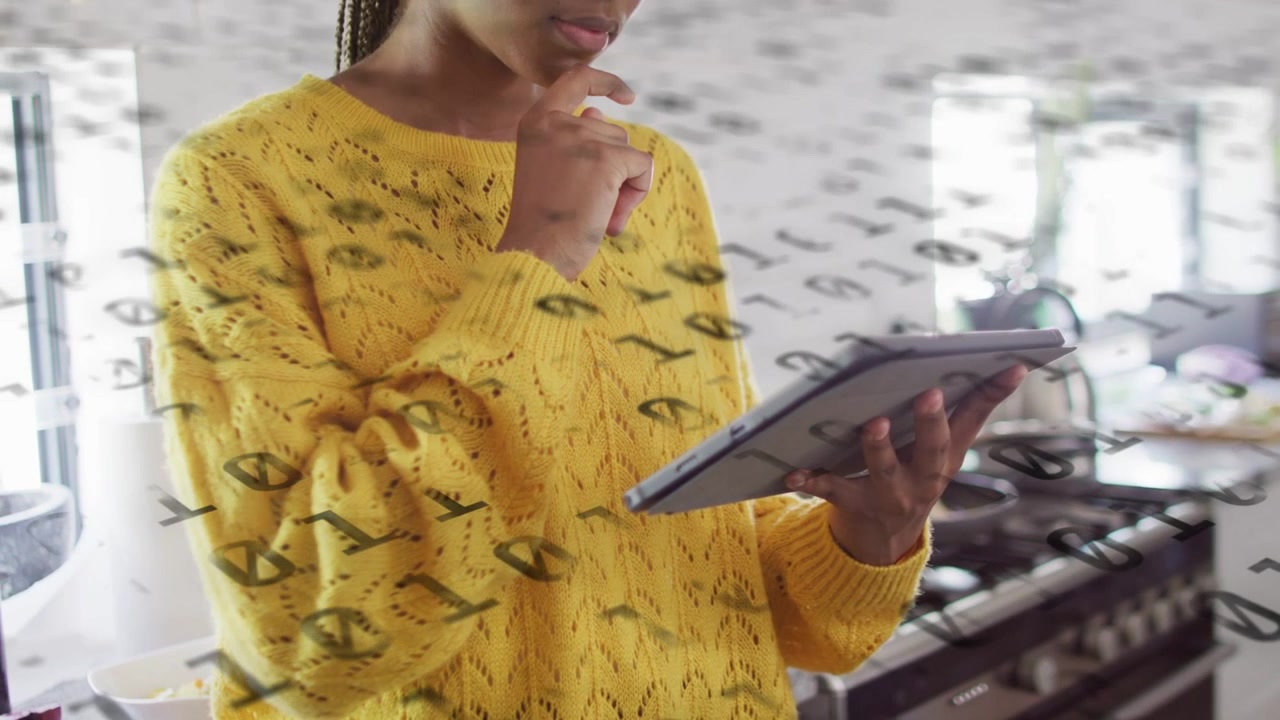 Woman tapping tablet and activating binary overlay while reviewing tech data near fruit and glass