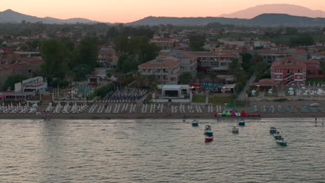 Zakynthos-Island-Greece-at-Sunset,-Laganas-Beach-and-Beachfront-Buildings,-Drone-Aerial-Sideway-View