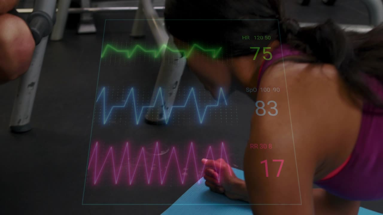 Client doing side-forearm plank on blue mat, causing HR or SpO2 waveforms, trainer noting for fitnes