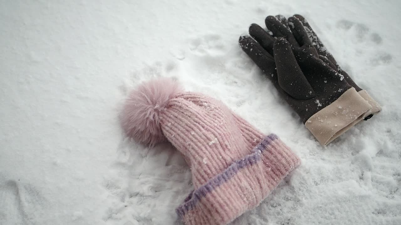 Gloves and hat in snow