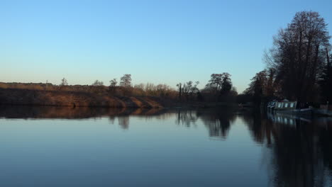 still canal on a winter morning, with moored canal boat