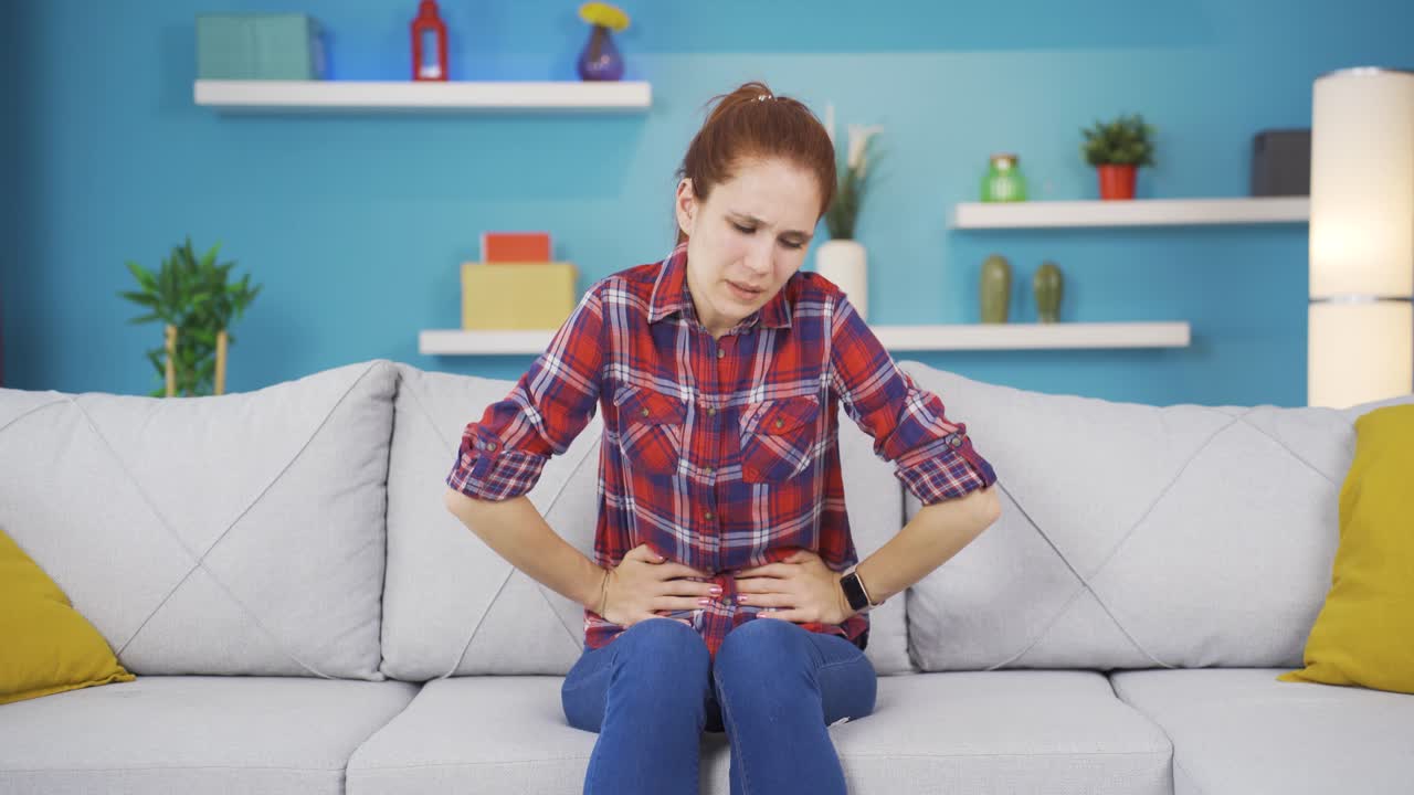 Young woman experiencing stomachache.
