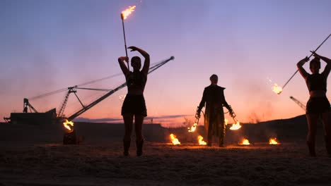 fire show. a group of professional artists performs a variety of fire facilities. boys and girls performed dances with fire in the night on the street in the park.