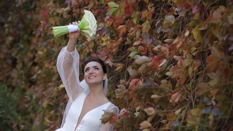 beautiful smiling bride on the background of autumn park beautiful smiling bride with a bouquet on the background of autumn park colorful nature