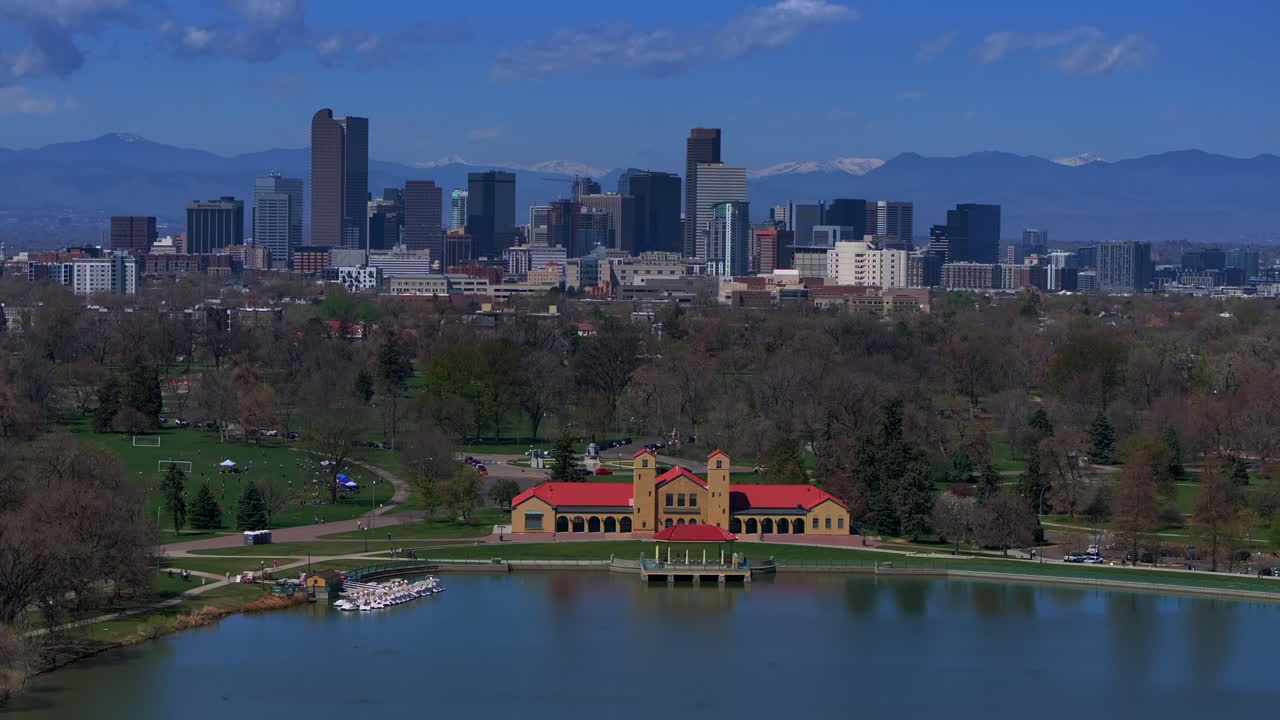 City Park Downtown Denver Colorado aerial drone springtime summer tree wildflower blossom sunny blue sky Ferril Duck Lake bike walking path green grass tall buildings forward pan up motion