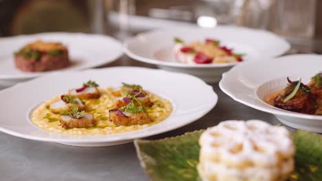 scallop dish on table with other fancy dishes, tight