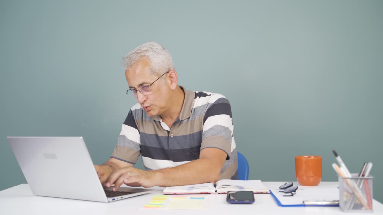 Man looking at laptop is happy and dancing.