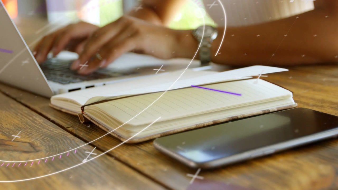 Woman starting typing on laptop for tech work, phone notebook, animated overlays moving over hands