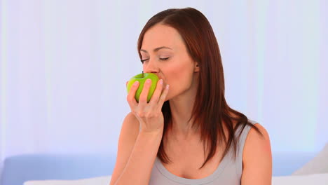 relaxed woman eating an apple