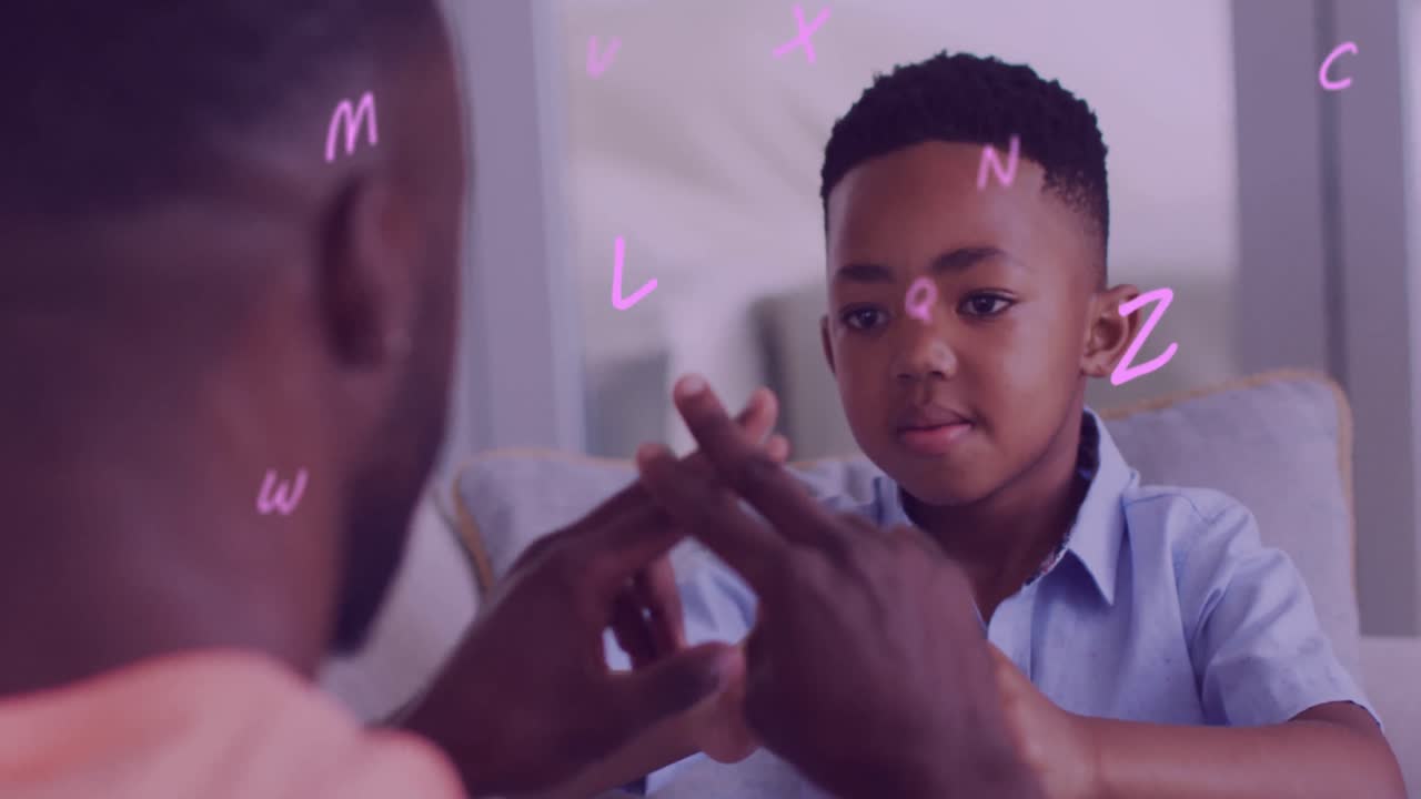 Animation of letters floating over happy african american father and son playing finger games