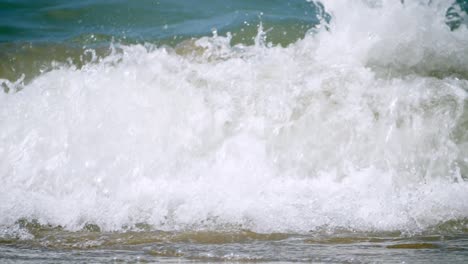 Foamy-waves-surging-and-crashing-as-it-pounds-the-beachfront-of-Pattaya-Beach,-located-in-Chonburi-province-in-Thailand