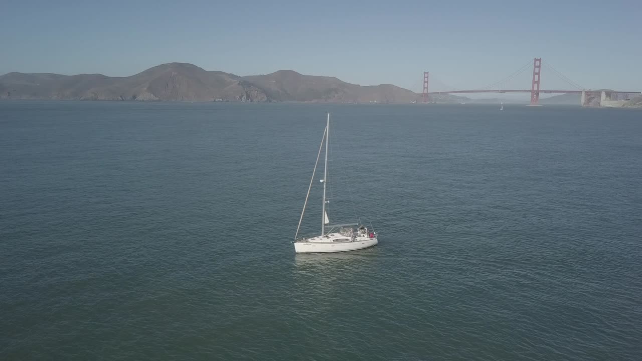A boat sails under the golden gate bridge Aerial footage
