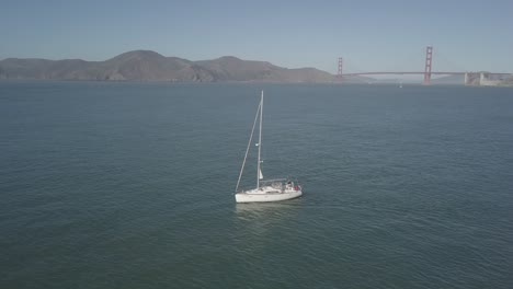 a boat sails under the golden gate bridge aerial footage