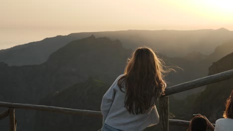 gorgeous girl with loose hair enjoying scenery - fine breeze at golden hours from viewpoint