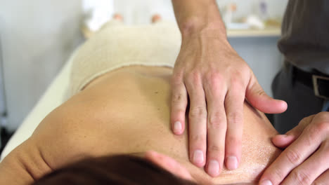 physiotherapist giving back massage to a woman