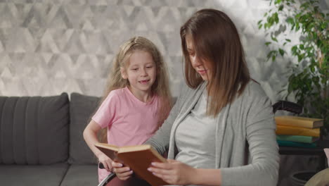 Toothless-little-girl-reads-book-with-mother-in-wheelchair