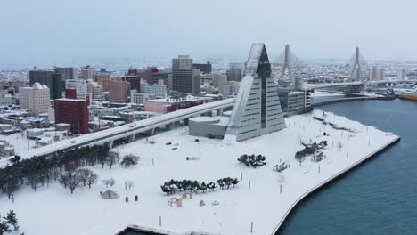 aomori city japan, aerial rise shot as snow covers the landscape