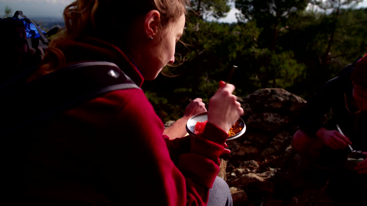 Young friends having a picnic on the mountain