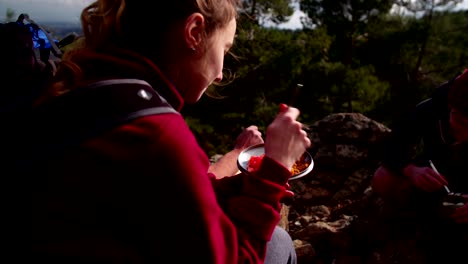 young friends having a picnic on the mountain