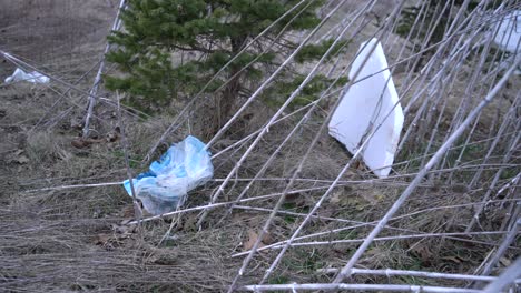 plastic bag litter laying on ground polluting earth and nature