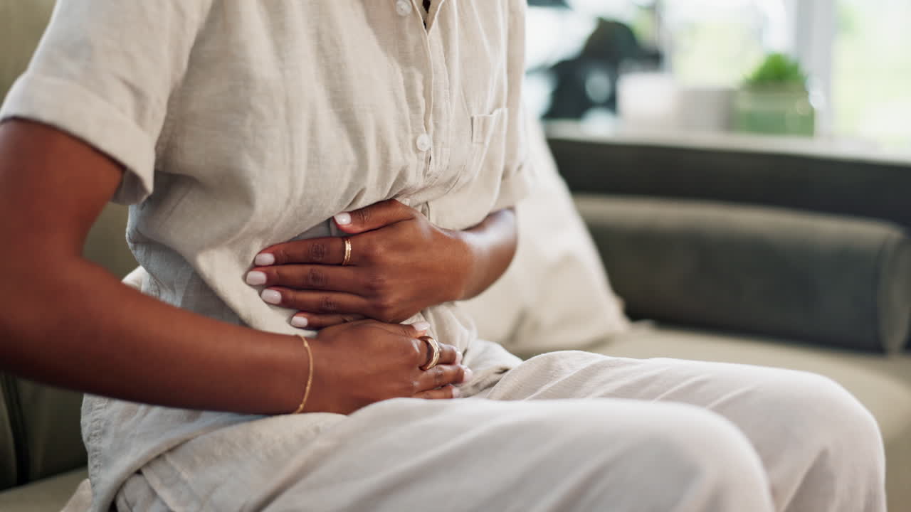 Hands, stomach pain and person with cramps