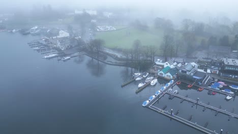 drone panning from the right to the left side of the frame, showing the famous boat village located near the windermere lake, in cumbria county, in united kingdom