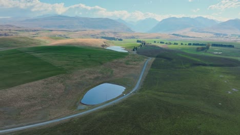 Scenic-aerial-view-of-rural-Kiwi-countryside-landscape-with-green-fields-at-Lake-Tekapo-in-Mackenzie-Basin-of-Canterbury,-New-Zealand-Aotearoa