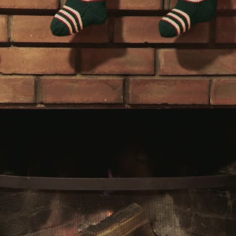 Christmas-gift-socks-hang-over-the-fireplace-where-the-fire-burns-3