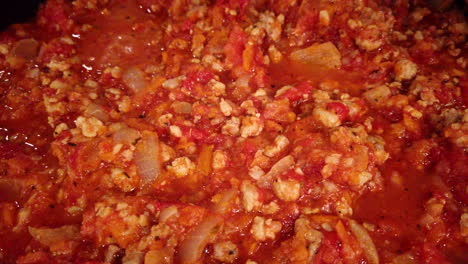 Zoom-out-on-a-boiling-traditional-bolognese-sauce