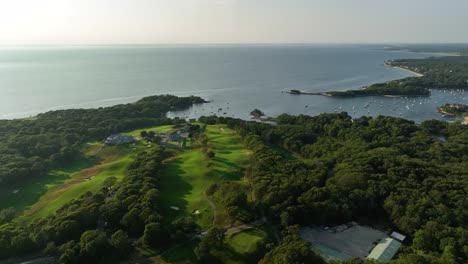 orbiting aerial of a cape cod golf course looking out over the water