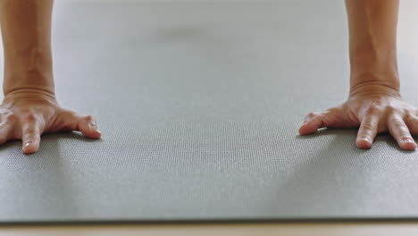 close-up-yoga-woman-practicing-on-exercise-mat-training-downward-facing-dog-pose-stretching-flexible-body-in-workout-studio-enjoying-healthy-lifestyle