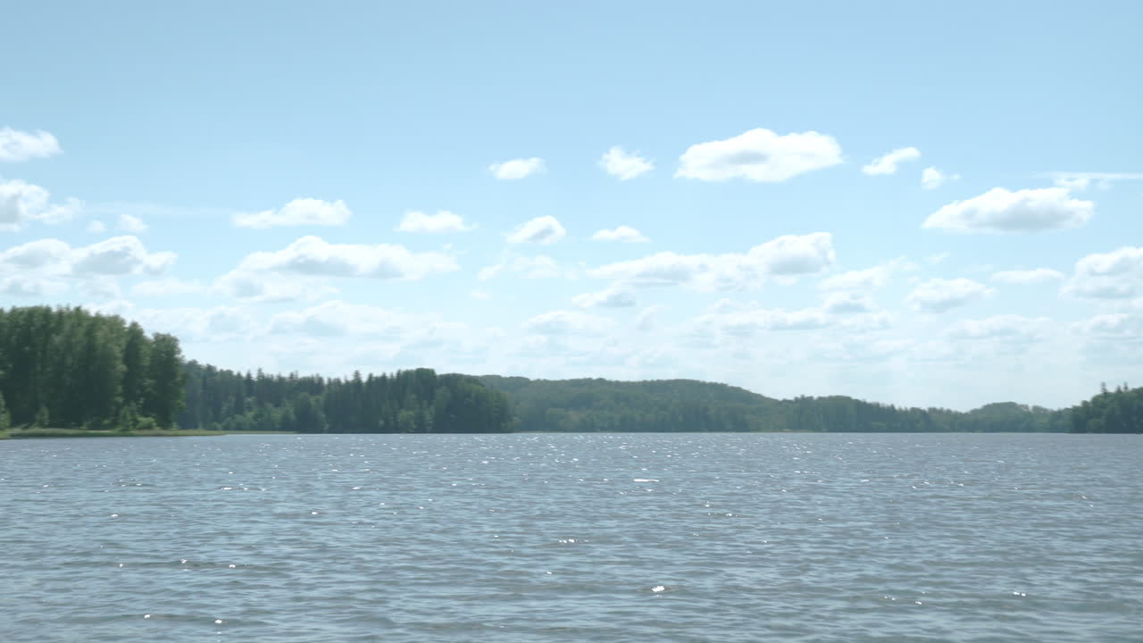 Lake of Pühajärv. Sunny day, beautiful clouds Sparkling water. Panorama to left.