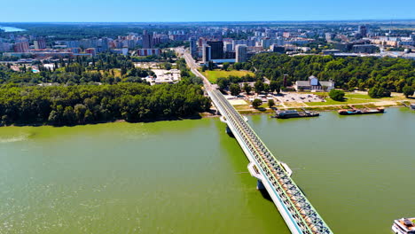 footage over the danube river crossed by the old bridge. picturesque view of bratislava, slovakia from top perspective.