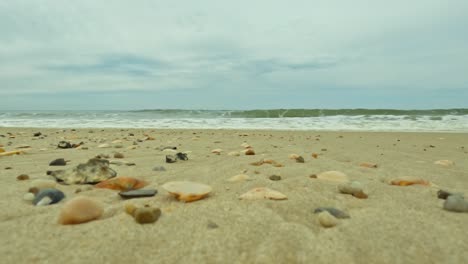 waves coming over a beach from low perspective, realistic and daytime