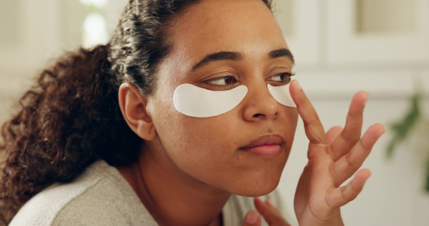 Young Woman Applying Under-Eye Patches for Skincare Routine