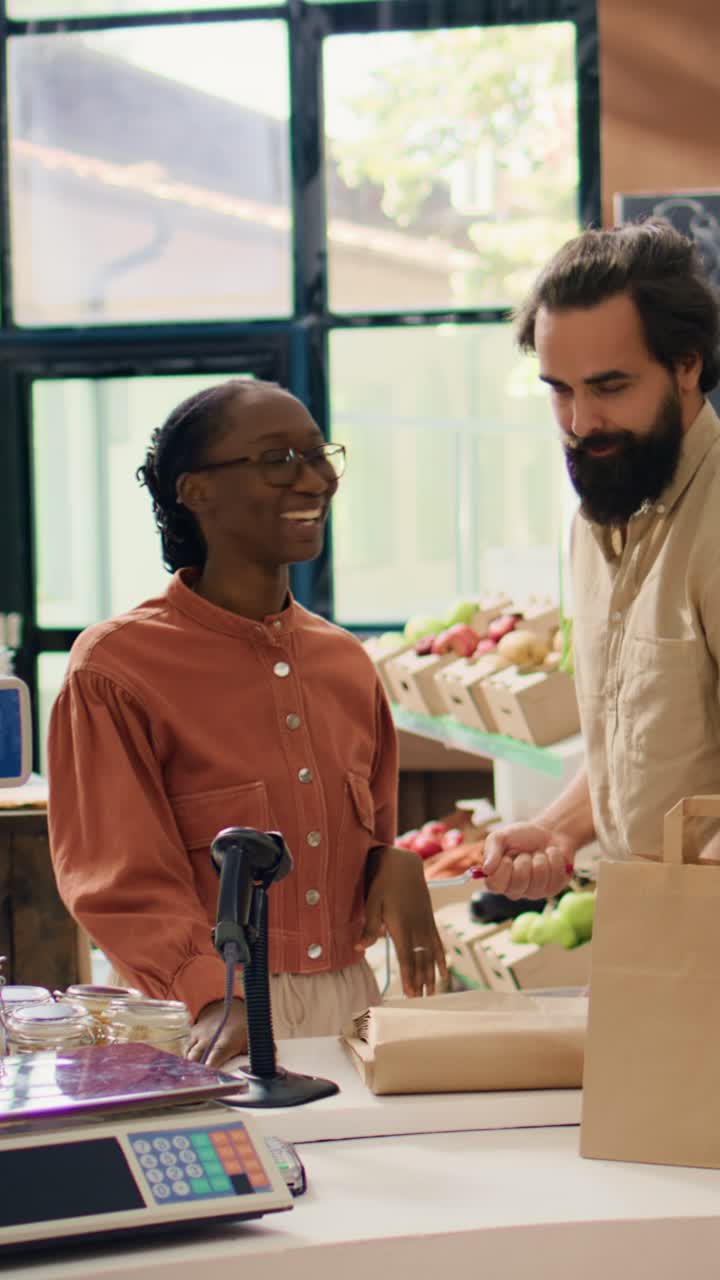 Vídeo vertical: un vendedor ayuda a un cliente en un supermercado