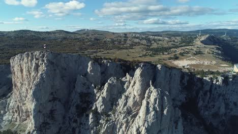 aerial view of a mountainous landscape with a flag on the peak