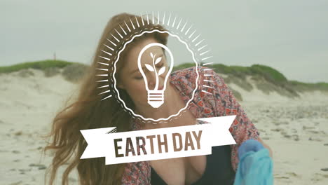 earth day light bulb animation over woman cleaning beach
