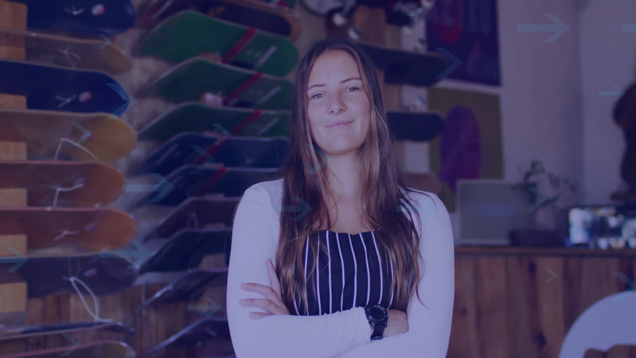 Standing confidently in skateboard shop, woman crossing arms and smiling