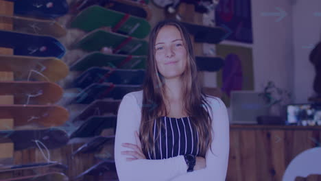 standing confidently in skateboard shop, woman crossing arms and smiling