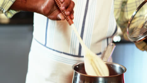 Senior-man-preparing-food-in-kitchen