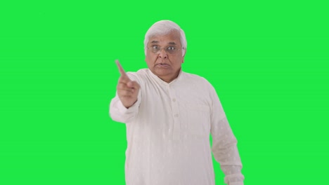 Angry-Indian-old-man-stopping-someone-Green-screen