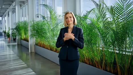 businesswoman expressing gratitude in office environment