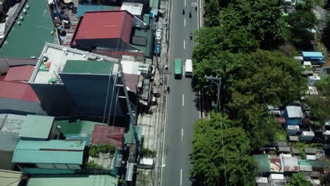 Top-Down-Drone-shot-of-Cars-passing-by-on-streets-of-Manila,-Philippines