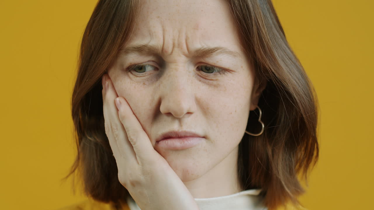 Young woman experiencing facial pain